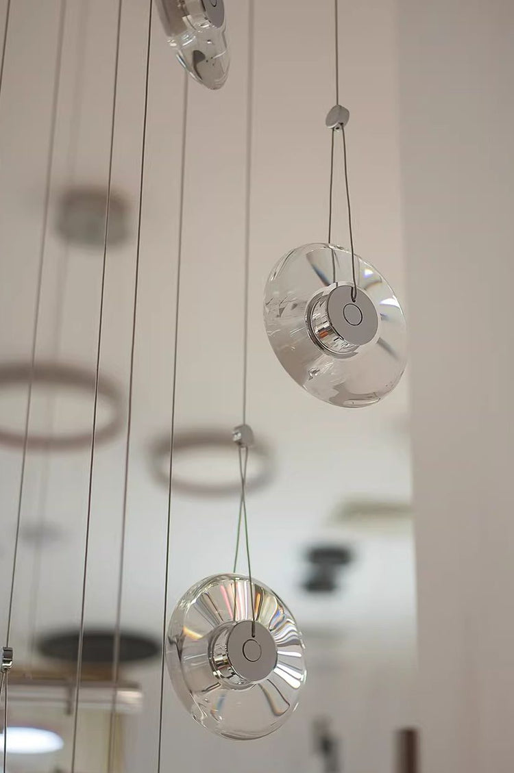 Modern minimalist luxury floating crystal chandelier | Minimalist artistic translucent disc design | Nordic style lighting fixture for living room, dining room, and staircase.